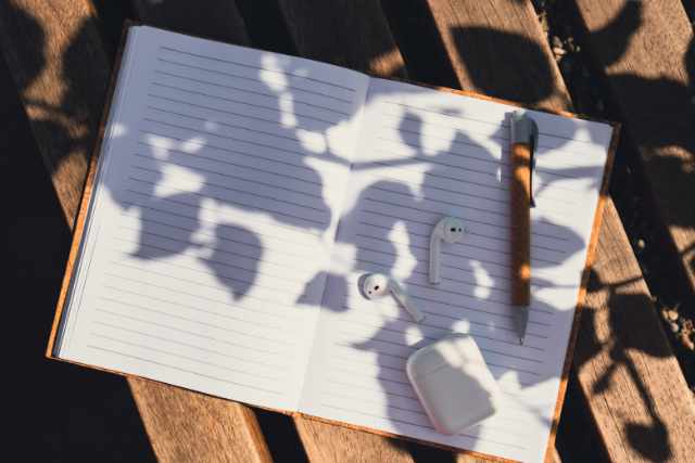 A curated desk with notebooks and natural light